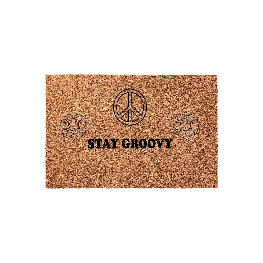 Stay Groovy coir doormat featuring a retro 70s aesthetic with a black peace sign and two daisy flower icons printed on a natural brown fiber background, creating a fun and welcoming entrance for your home or front porch decor.