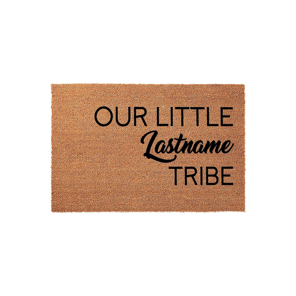 Personalized family name coir doormat featuring the phrase Our Little Lastname Tribe in bold black lettering, set against a natural tan textured fiber background for a welcoming and rustic front porch entrance decor style.