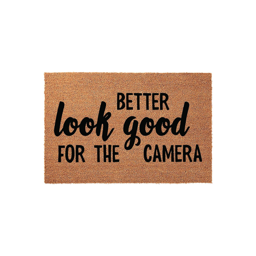 Funny Look Good For The Camera doormat featuring a natural coir fiber texture and bold black typography, displayed against a clean white background to highlight the humorous welcome message for your front porch or entryway decor.