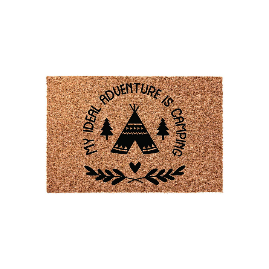 Camping Adventure Coir Doormat featuring a black printed teepee, pine trees, and the text My Ideal Adventure Is Camping, set against a natural brown coconut fiber background for a rustic outdoor entryway or cabin decor aesthetic.