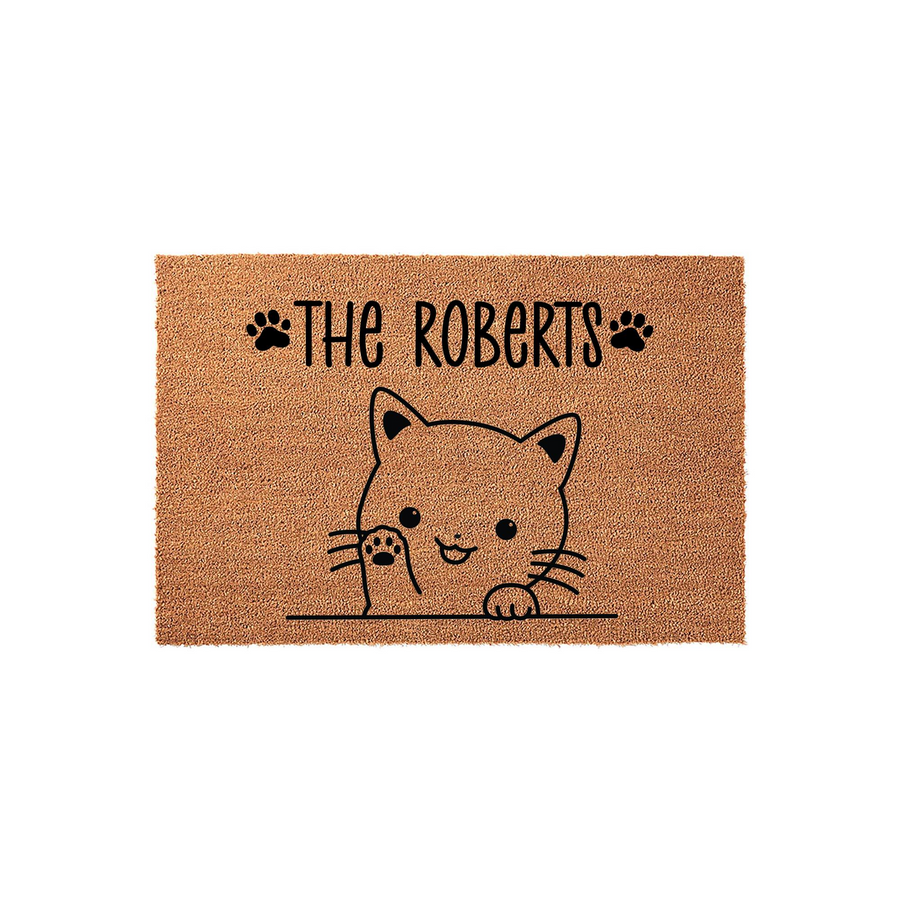Personalized cat family doormat featuring a cute illustrated kitten peeking over a line with black paw prints and custom family name text on a natural coir fiber background, creating a welcoming entrance for any cat lover home.