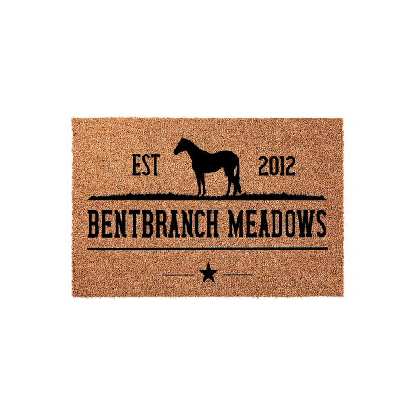 Personalized horse farm doormat featuring a black silhouette of a horse standing in a meadow, with the text Bentbranch Meadows and an established year printed on a natural tan coir fiber background for a rustic outdoor entryway