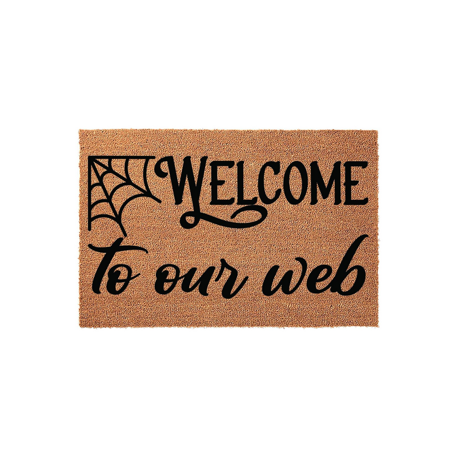 Halloween Welcome to Our Web doormat featuring a natural coir fiber texture and black printed text with a spider web graphic, creating a festive and spooky entryway decor piece for the fall season on a plain white background.