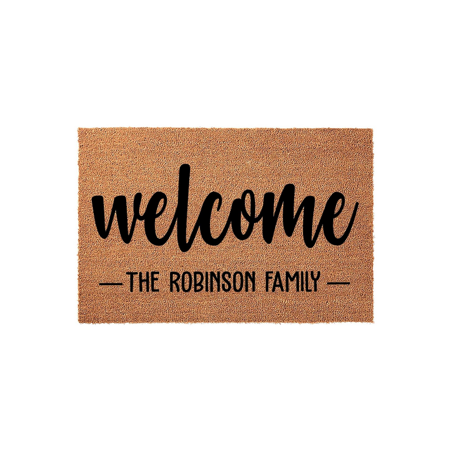 Personalized family name welcome doormat made of natural coir fiber, featuring the word welcome in a bold script font above a custom line for a family name, set against a clean white background for a classic home entryway decor