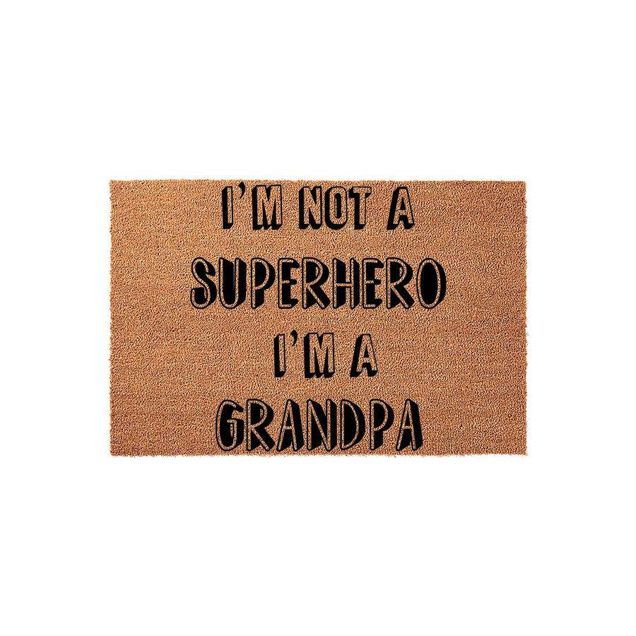 Funny Grandpa doormat made of natural coir fiber, featuring bold black text that reads I am not a superhero I am a Grandpa, displayed against a clean white background for a clear view of the humorous entryway decor design.