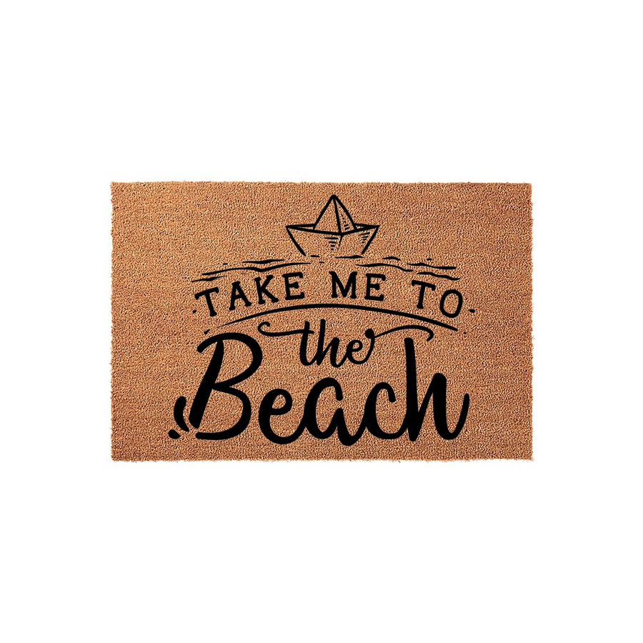 Take Me To The Beach coir doormat featuring a hand-drawn paper boat illustration and black typography on a natural tan fiber background, creating a coastal aesthetic for your front porch or entryway decor.