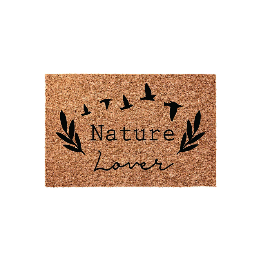 Nature Lover Coir Doormat featuring a rustic tan fiber texture with black printed text, stylized leafy branches on the sides, and a flock of birds flying above, creating a welcoming outdoor aesthetic for any front porch or