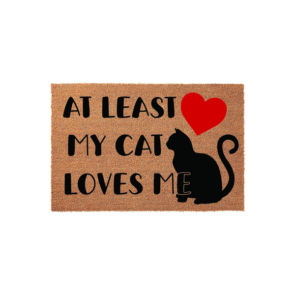At Least My Cat Loves Me coir doormat featuring a black cat silhouette and a bright red heart, designed with a humorous message for pet owners on a natural brown textured fiber surface against a clean white studio background.