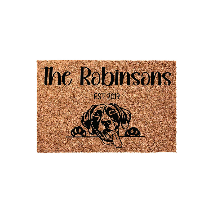 Personalized dog family name doormat featuring a cute Labrador Retriever peeking over the edge, printed on natural coir fiber with a custom family name and established year for a welcoming front porch entrance that celebrates pet
