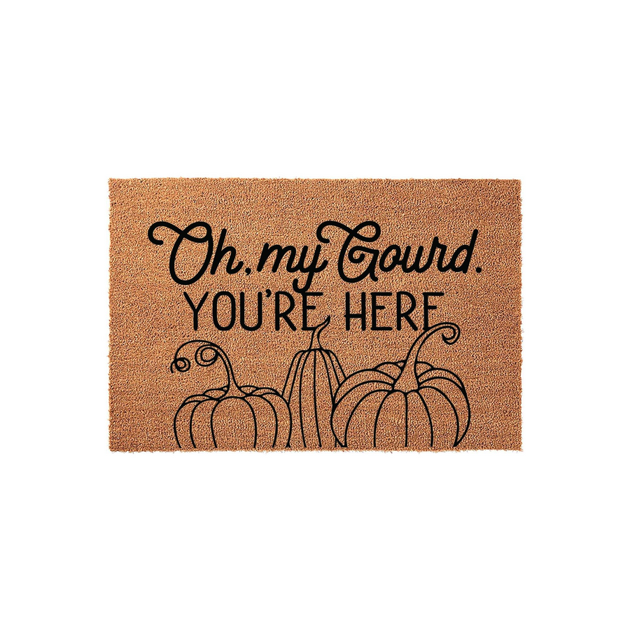 Oh My Gourd You Are Here fall doormat made of natural coir fiber, featuring a playful black script and block letter design with three illustrated pumpkins at the bottom for a festive autumn porch decor look on a plain white