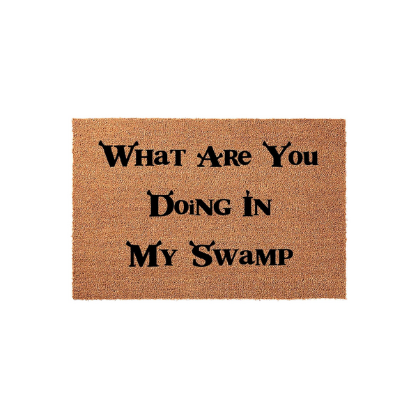 Funny Shrek themed coir doormat featuring the iconic quote What Are You Doing In My Swamp printed in black lettering on a natural tan fiber background, perfect for adding a touch of movie humor to your front porch or entryway