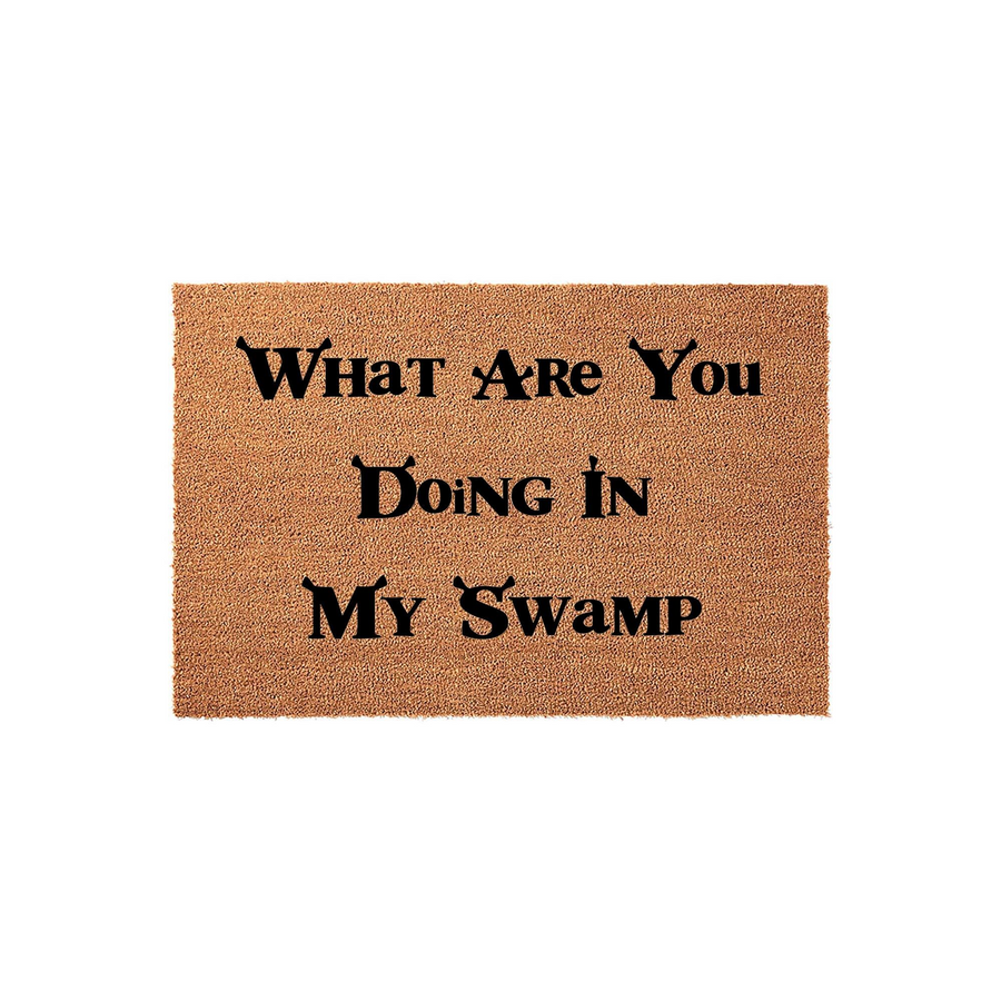 Funny Shrek themed coir doormat featuring the iconic quote What Are You Doing In My Swamp printed in black lettering on a natural tan fiber background, perfect for adding a touch of movie humor to your front porch or entryway