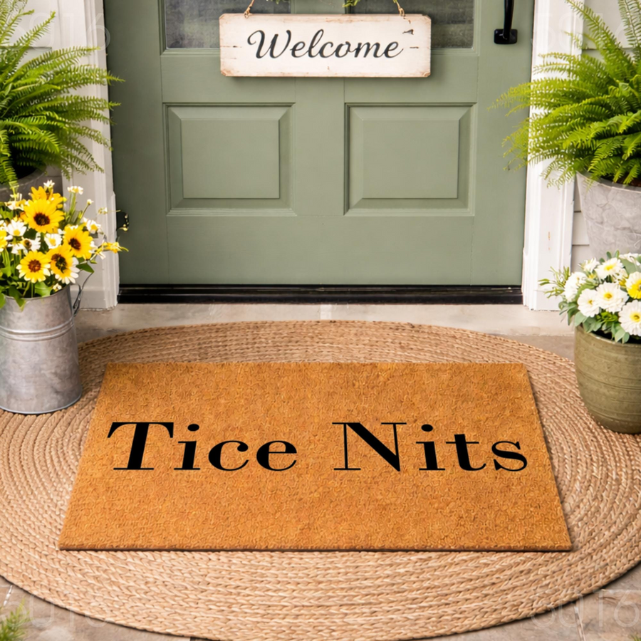 Personalized Coir Welcome Doormat featuring custom text in a classic black font, displayed on a round jute rug in front of a green front door with a welcome sign, potted ferns, and bright yellow sunflowers in a rustic metal
