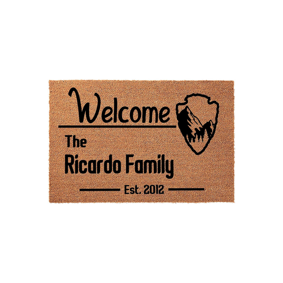 Personalized Family Name Welcome Doormat featuring a rustic mountain arrowhead graphic on a natural coir fiber mat, customized with a family name and established year to create a welcoming entrance for any home or front porch
