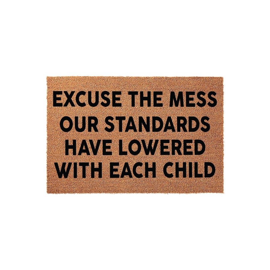Funny Excuse the Mess Our Standards Have Lowered With Each Child doormat made of natural coir fiber, featuring bold black text centered on a rectangular brown mat that adds a humorous touch to any home entryway or front porch