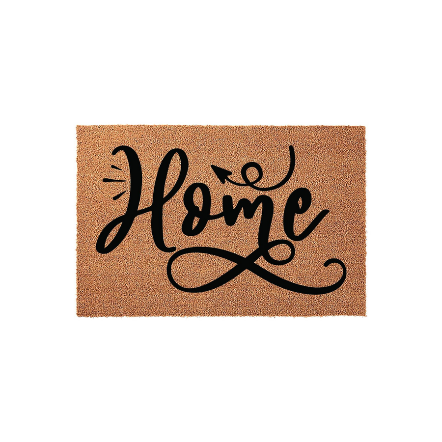 Home coir doormat featuring a natural tan fiber texture and bold black script lettering that spells out the word Home with a decorative arrow flourish, creating a welcoming entrance piece for any front porch or entryway decor.