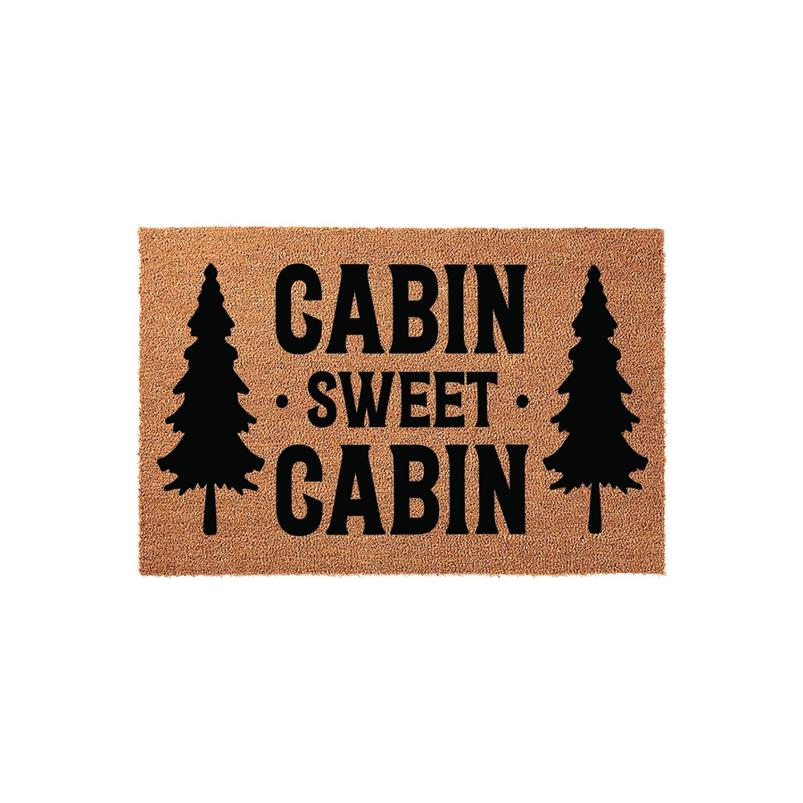 Cabin Sweet Cabin coir doormat featuring a rustic natural fiber texture with bold black text and pine tree silhouettes on each side, creating a cozy outdoor entrance decor piece for your mountain home or vacation rental property.