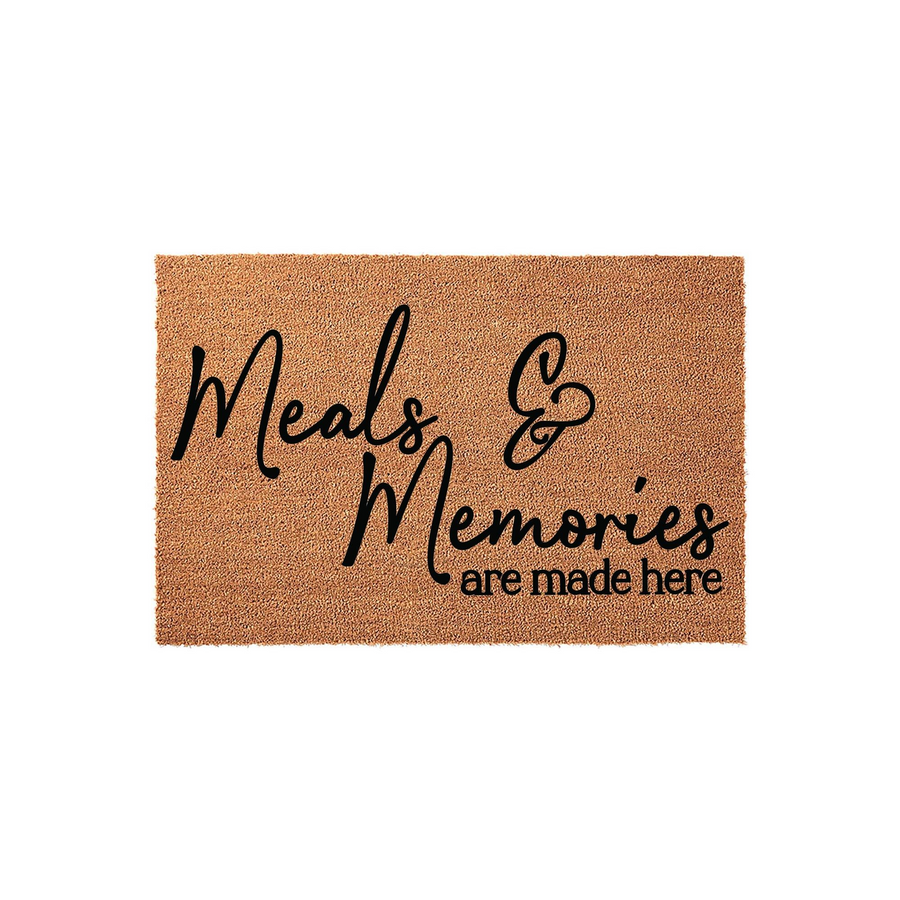 Meals and Memories are made here coir doormat featuring a natural brown fiber texture and bold black script lettering, providing a welcoming and rustic touch to your kitchen or dining room entrance on a clean white background.