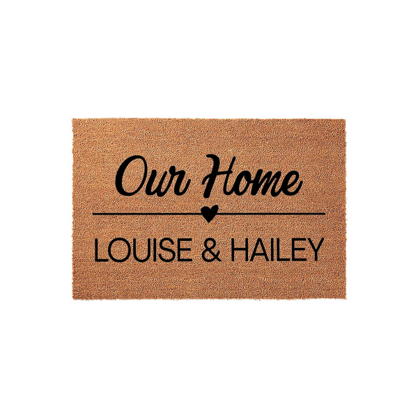 Personalized coir doormat for our home featuring a custom name design with a small heart icon, presented on a clean white background to showcase the durable natural fiber texture and bold black lettering for a welcoming entryway.