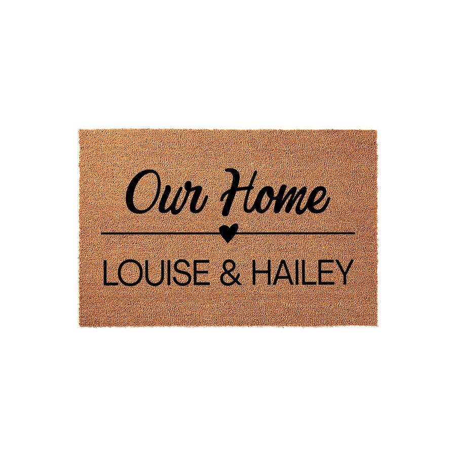 Personalized coir doormat for our home featuring a custom name design with a small heart icon, presented on a clean white background to showcase the durable natural fiber texture and bold black lettering for a welcoming entryway.