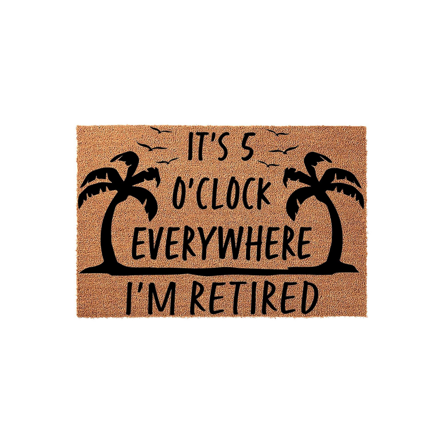 Retirement themed natural coir doormat featuring black palm tree silhouettes and the text It is 5 o'clock everywhere I'm retired, set against a plain white background for a clean and tropical front porch decor aesthetic.