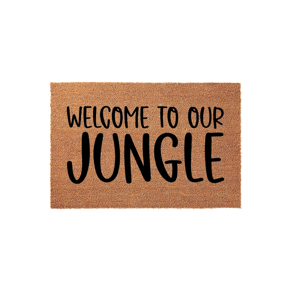 Welcome to Our Jungle coir doormat featuring bold black typography printed on a natural tan fiber background, creating a fun and inviting entryway decor piece for any plant lover or home with a tropical aesthetic.