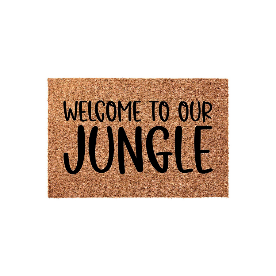 Welcome to Our Jungle coir doormat featuring bold black typography printed on a natural tan fiber background, creating a fun and inviting entryway decor piece for any plant lover or home with a tropical aesthetic.