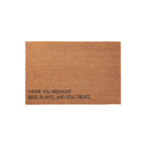Funny coir doormat featuring the text I Hope You Brought Beer, Plants, and Dog Treats printed in black ink on a natural brown fiber background, making it a humorous welcome mat for any home entrance or front porch decor.
