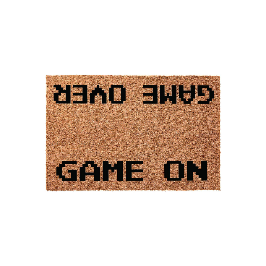 Game Over Game On doormat featuring a textured brown coir surface with black pixelated text that reads Game Over at the top and Game On at the bottom, designed for gamers to place at their front door for a fun and welcoming home
