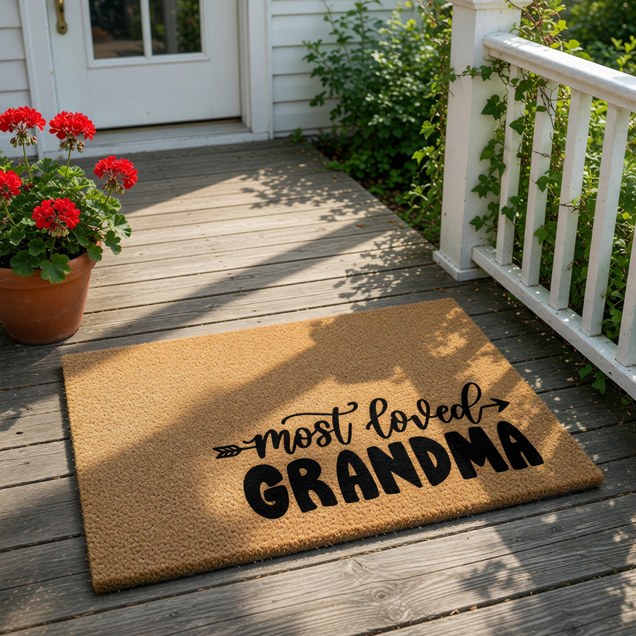 Most Loved Grandma coir doormat featuring a natural fiber welcome mat design with black script text, perfect for a front porch entry or home decor, celebrating a special grandmother with this durable outdoor floor mat for the