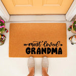 Grandma doormat for front porch featuring natural coir fiber material with black text that reads most loved GRANDMA, a stylish outdoor welcome mat for home entryways that makes a thoughtful housewarming or birthday present for
