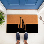 In and Out arrow doormat featuring a modern two-tone design with natural coir and black sections, perfect as a funny front porch welcome mat for your home entrance, housewarming gift, or unique outdoor floor decor for any