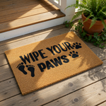 Wipe Your Paws doormat with a natural coir fiber texture, featuring black text and paw print graphics for a fun pet lover entryway rug that serves as a durable outdoor welcome mat for dog owners and cat lovers at the front door.