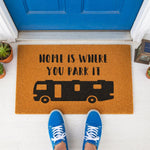 a door mat that says home is where you park it