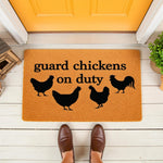 Guard chickens on duty doormat featuring black chicken silhouettes on a natural fiber welcome mat, placed on a front porch for a funny farm house decor look that greets guests with a humorous animal themed entrance floor rug.