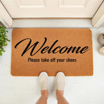 Welcome please take off your shoes doormat, a natural fiber coir welcome mat for front porch entryways, featuring bold black script text on a durable brown rug that adds a stylish touch to your home decor and entryway floor.