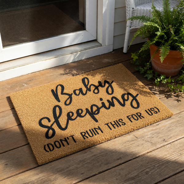 Baby sleeping doormat with funny text, a natural coir fiber welcome mat for new parents that reads Baby sleeping don't ruin this for us, a humorous front porch rug for a nursery or home entrance to keep visitors quiet and