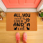 Cat lover welcome doormat featuring a funny quote about needing love and a cat, printed on a natural fiber coir mat.