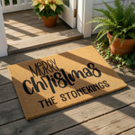 Personalized Merry Christmas doormat featuring custom family name text on a natural coir fiber mat, this holiday welcome mat is a festive outdoor floor rug for your front porch decor during the winter season and holiday home