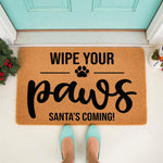 Wipe Your Paws Santa Is Coming doormat, a natural coir fiber welcome mat for pet owners featuring a festive holiday design with a paw print, perfect for a front porch entryway during the Christmas season to keep floors clean and