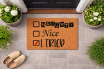Naughty Nice I Tried funny doormat for front porch entry, featuring a checklist design on natural coir fiber.