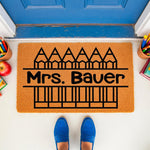 Personalized teacher doormat with pencil design, a custom welcome mat for classroom entryways featuring school supplies, perfect for a teacher appreciation front porch decor or a unique school year welcome home entrance rug.