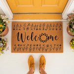 Floral Welcome Doormat with a natural coir fiber texture and black botanical line art, featuring a sunflower design on a front porch entryway mat that adds a stylish touch to your home decor for guests and visitors to enjoy.