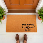 Personalized Mr and Mrs wedding doormat for a new home, featuring a custom last name and established year on natural coir fiber.