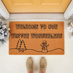 Winter Wonderland welcome doormat featuring a festive snowman and pine tree design on natural coir fiber, perfect for holiday porch decor and seasonal entryway floor mats to greet guests during the cold weather months.