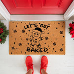 Funny Christmas doormat featuring a gingerbread man in a Santa hat with the text Let's Get Baked, this natural coir welcome mat is a humorous holiday front porch decor piece for your home entrance during the winter festive season.