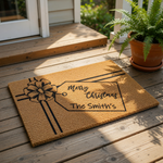 Personalized Christmas gift doormat featuring a festive bow and a custom family name tag design on natural coir fiber, this holiday welcome mat is a durable outdoor floor rug for your front porch decor during the winter season.