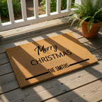 Personalized Merry Christmas doormat made of natural coir fiber, featuring a festive holiday design with custom family name text for a front porch entry, perfect for seasonal home decor and outdoor welcome mat floor covering