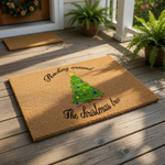 Rocking around the Christmas tree doormat featuring a festive holiday pine tree design with colorful lights and a gold star, perfect for a seasonal front porch welcome mat or a fun indoor entryway floor rug for the winter