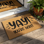 Yay You Are Here coir doormat with black text on a natural fiber rug, this funny welcome mat for front porch entryways features a cheerful greeting design that makes a stylish housewarming decor piece for any home entrance.